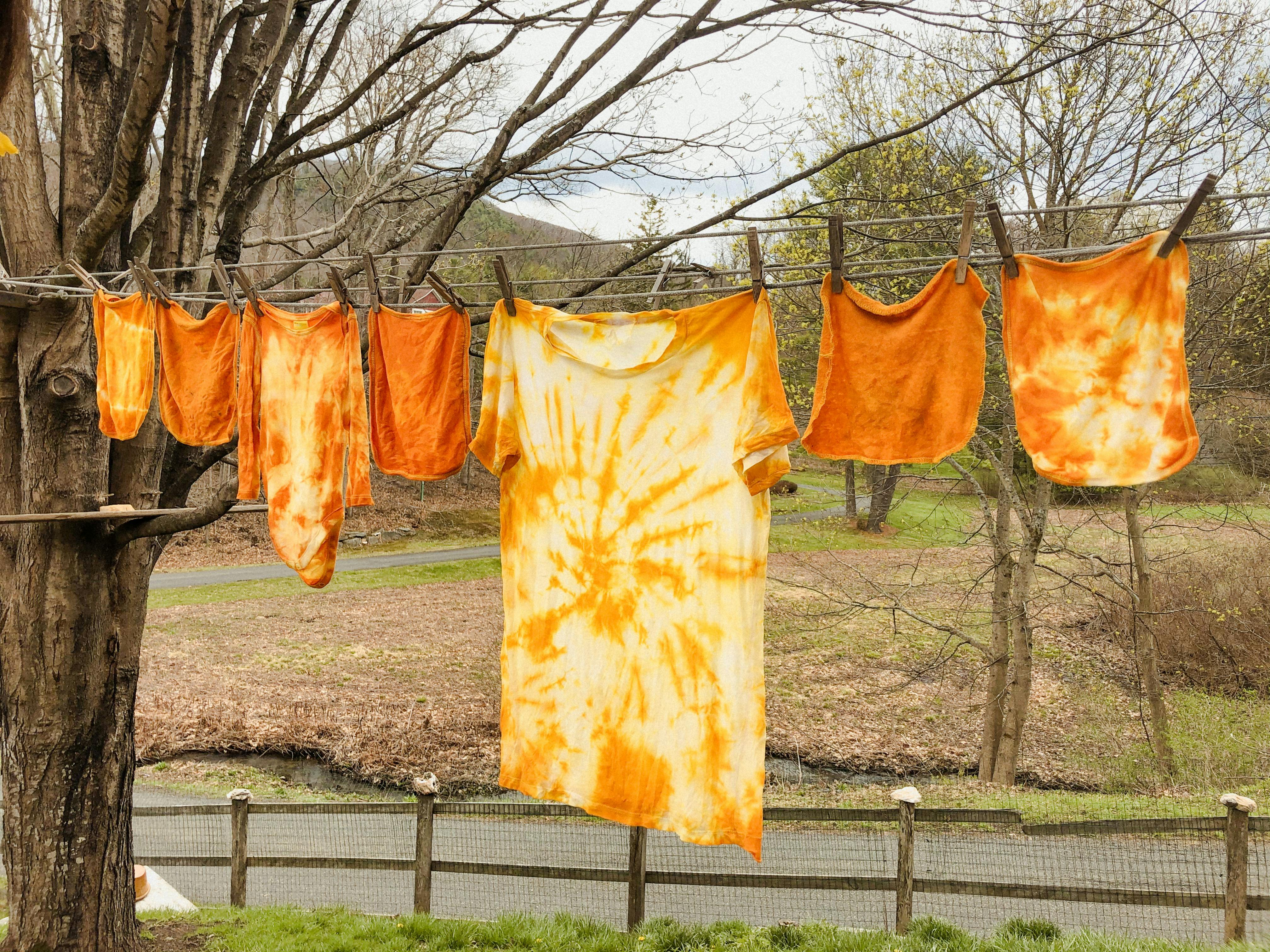  freshly tie dyed clothes hanging on a washing line