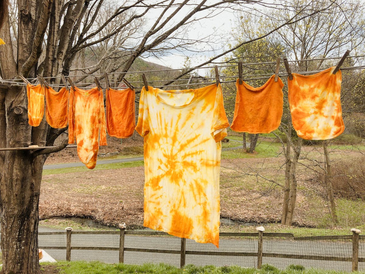  freshly tie dyed clothes hanging on a washing line