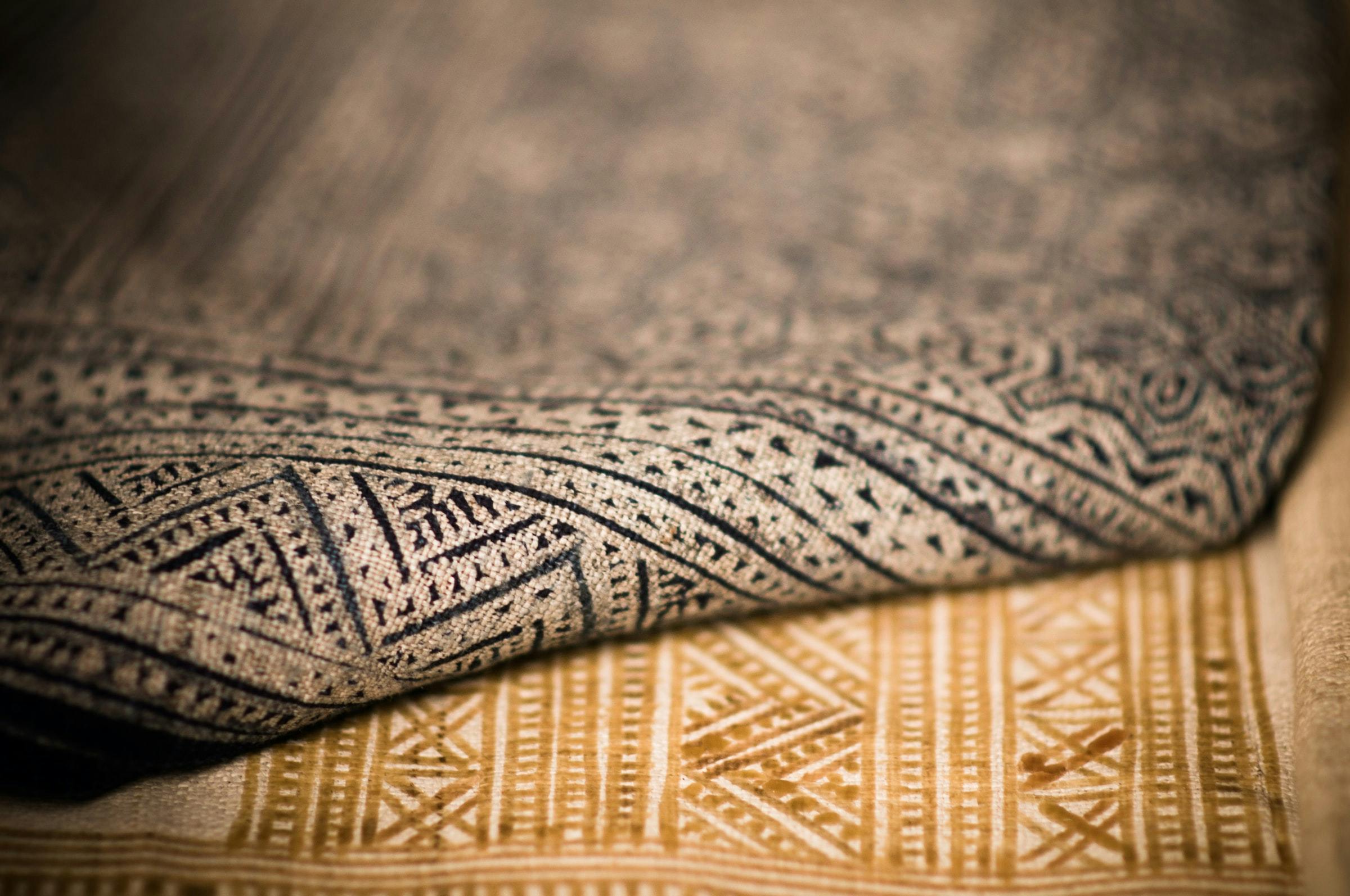 close up of traditionally printed natural fabrics in black and brown