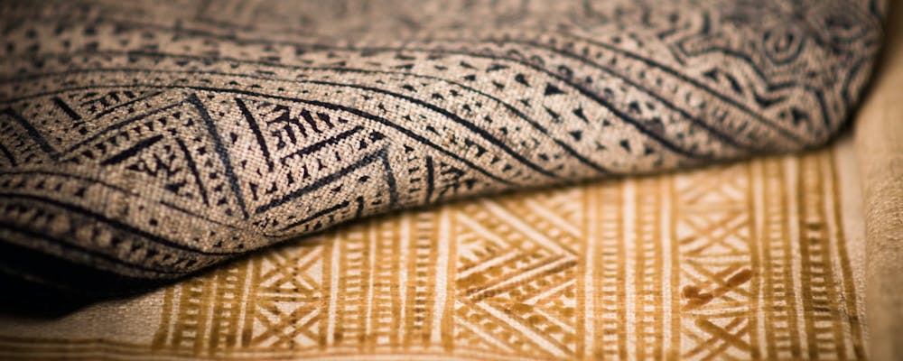  close up of traditionally printed natural fabrics in black and brown