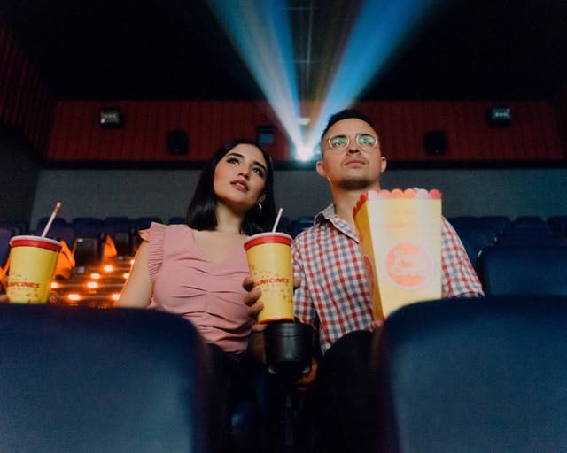 two people watching a film