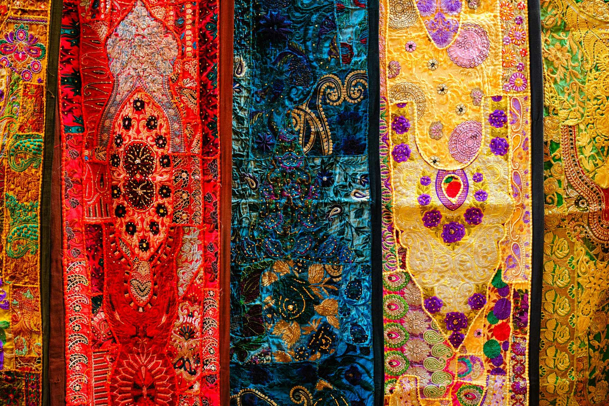  close up details of elaborate traditional textiles in bright colors