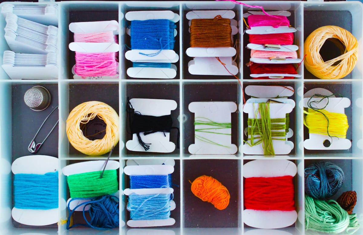  birdseye view of box of organised colourful threads