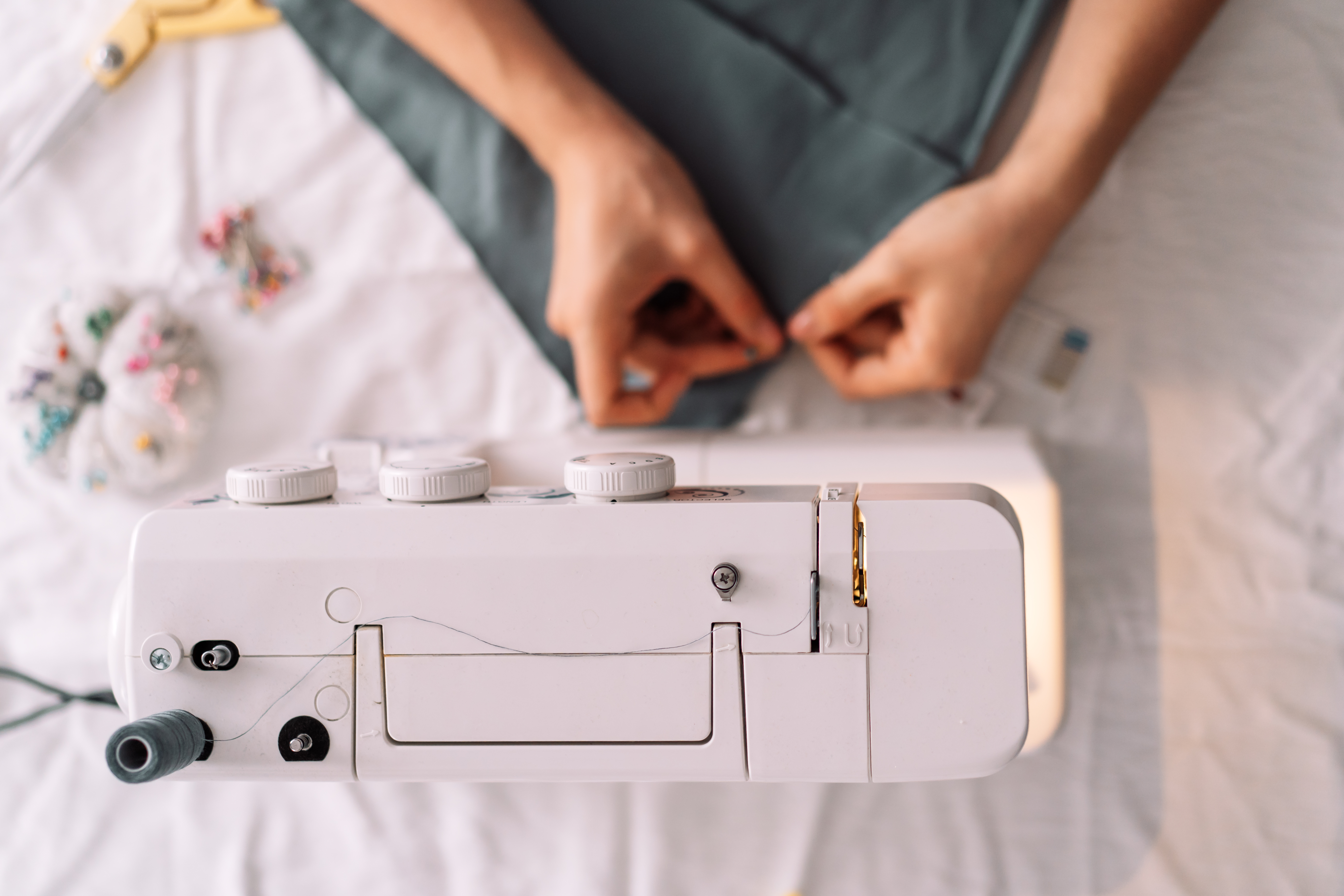 Overhead photo of hands at a sewing machine