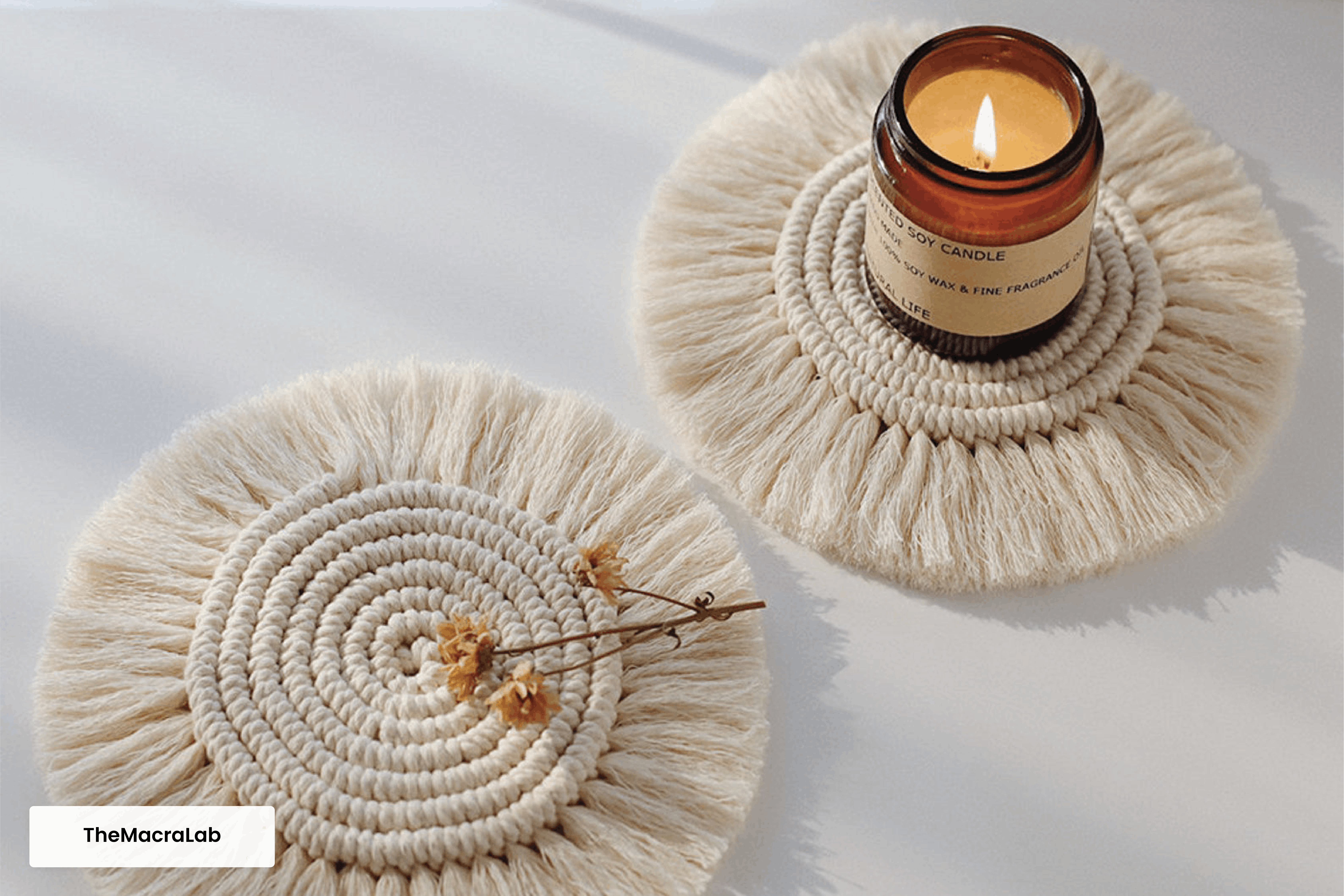  Two round macrame coasters with a candle.