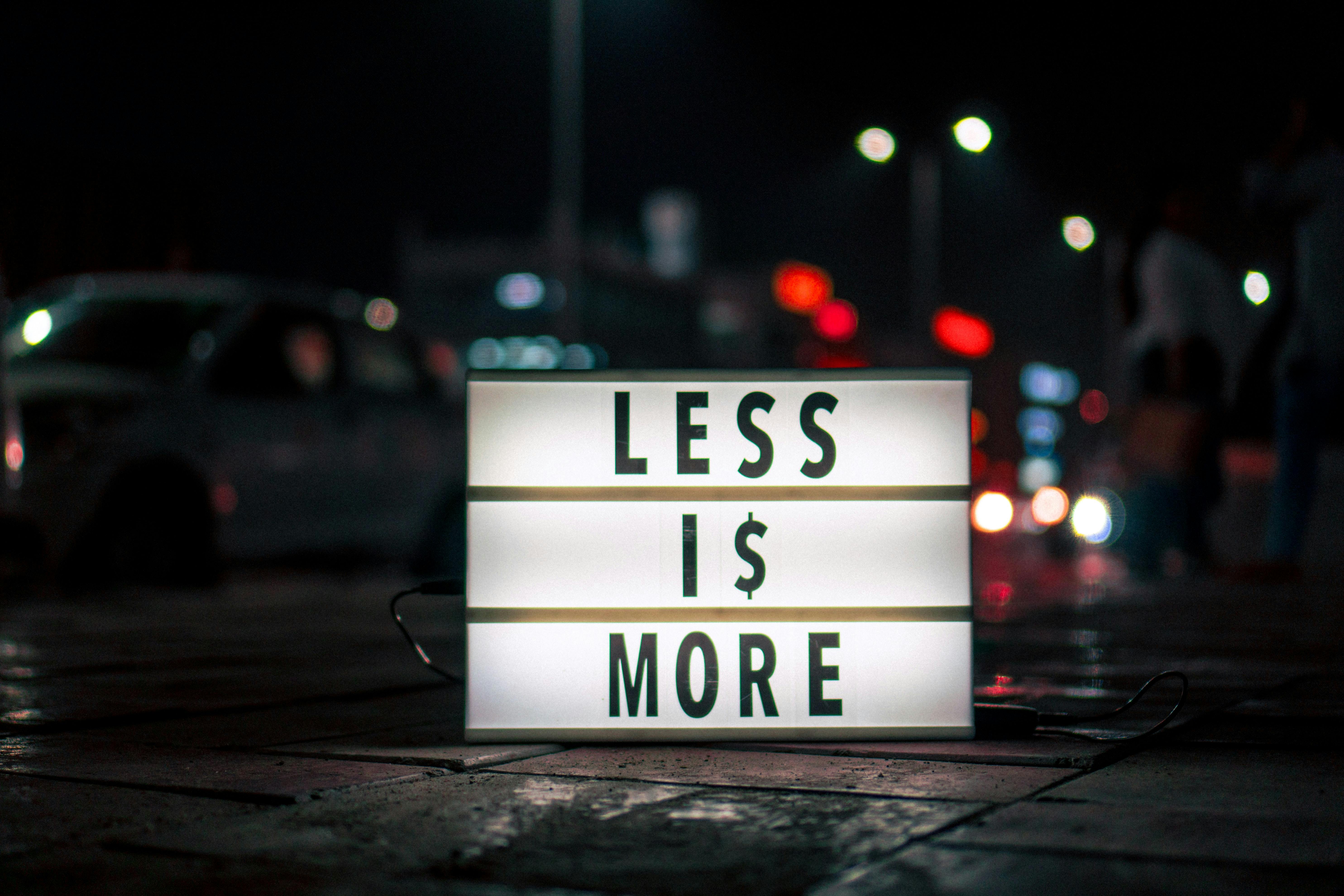 less i$ more signage using dollar sign instead of letter s