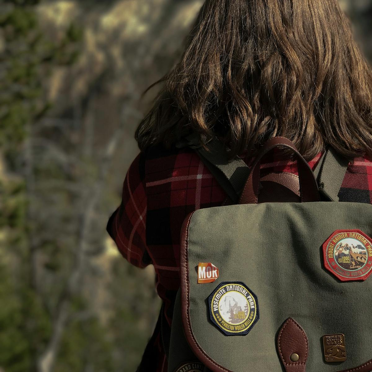  woman's outdoors backpack covered in fabric patches
