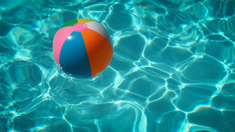 colourful beach ball in a swimming pool