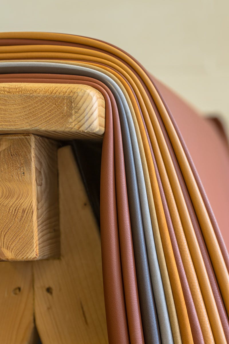  coloured leather hides on wooden rack