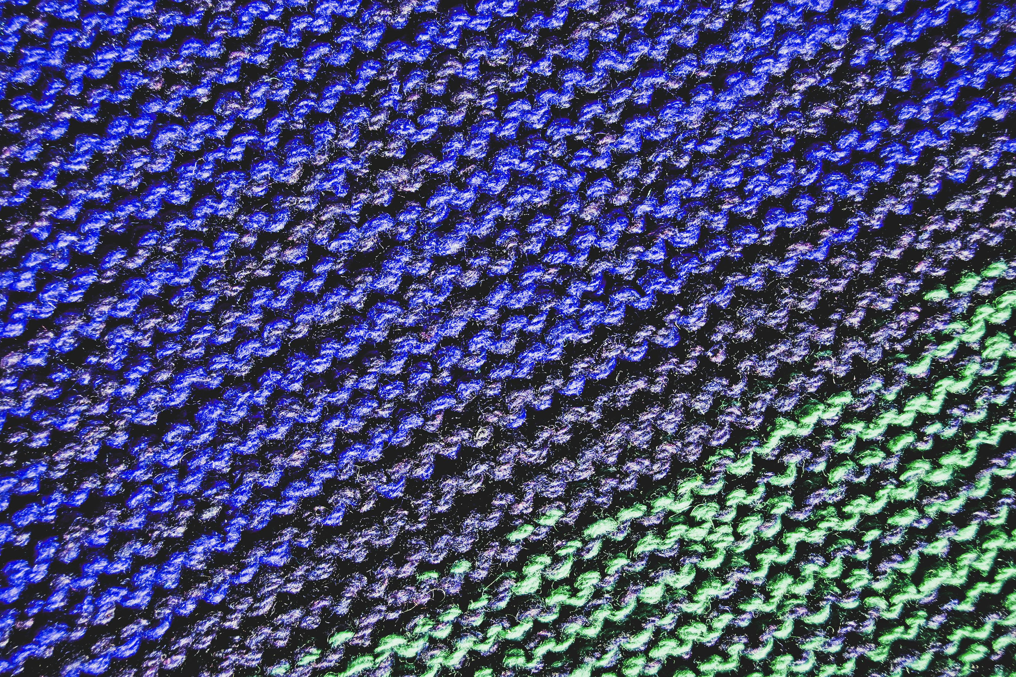  close up of knitted fabric with a blue to green gradient