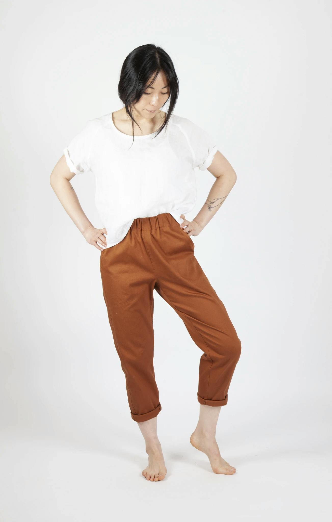  Woman Wearing Freerange Slack Pants in a Burnt Orange Color
