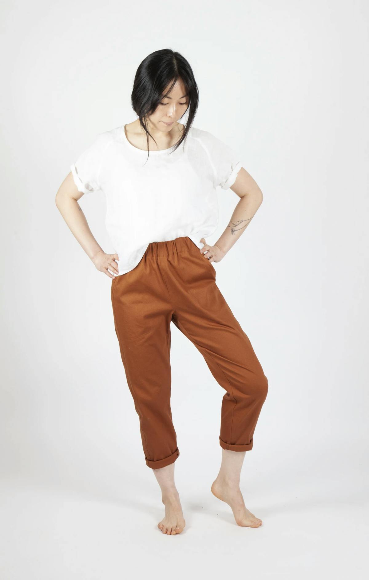 Woman Wearing Freerange Slack Pants in a Burnt Orange Color Woman Wearing Freerange Slack Pants in a Burnt Orange Color