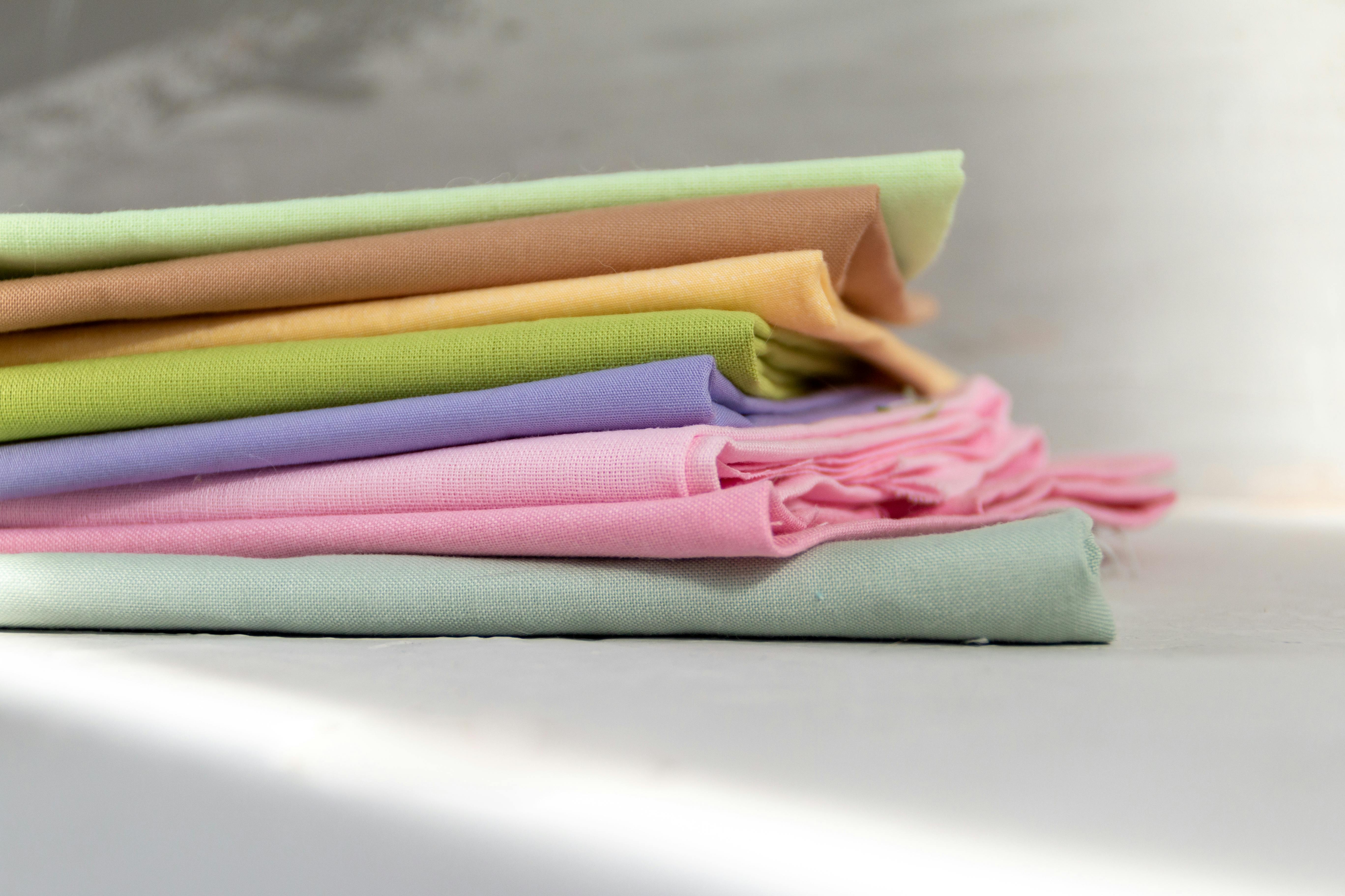  stack of colorful cotton fabrics folded on a table