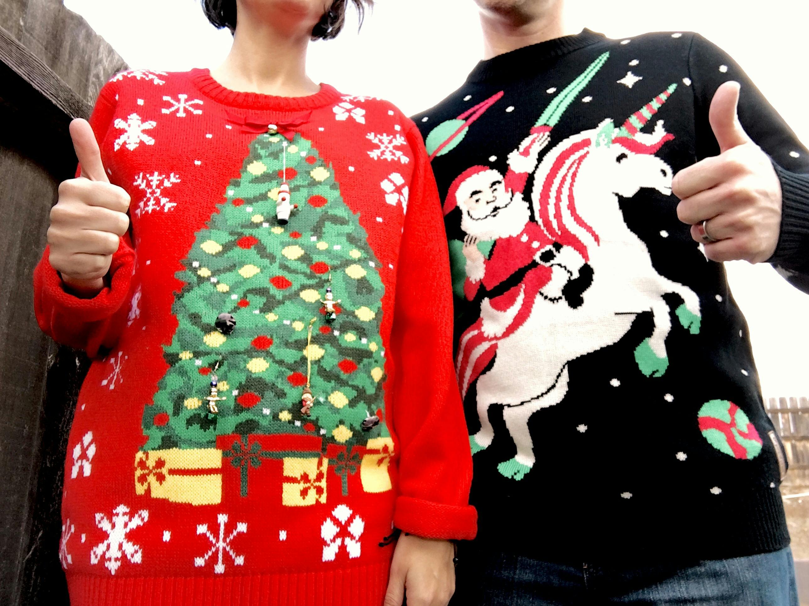 people wearing ugly christmas sweaters