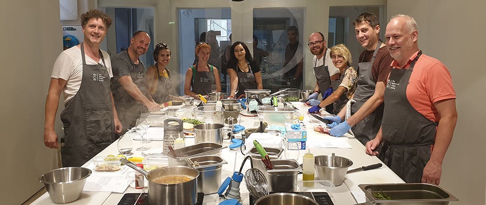  The team cooking together at a cooking class