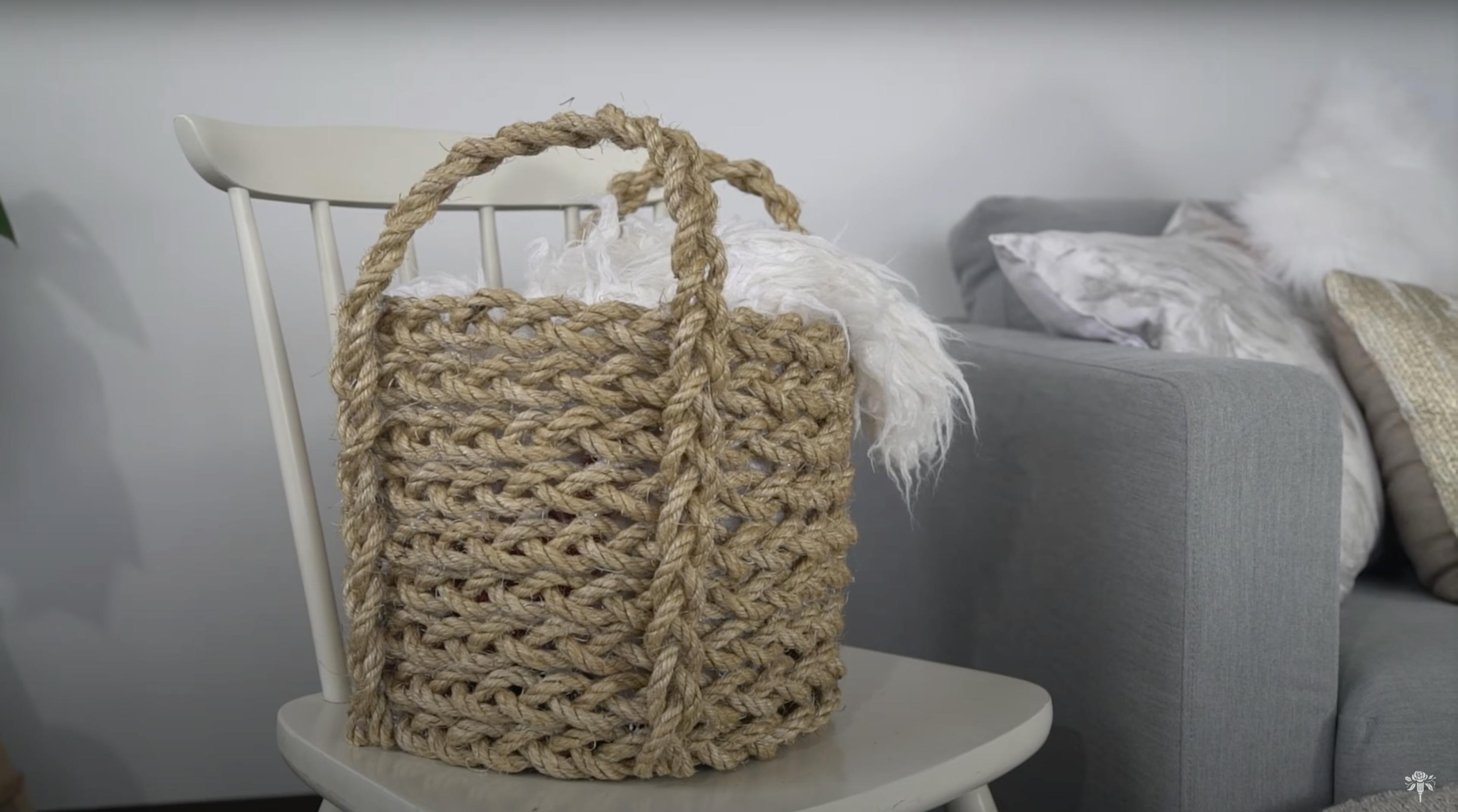  Blanket basket sitting on a chair next to a couch.