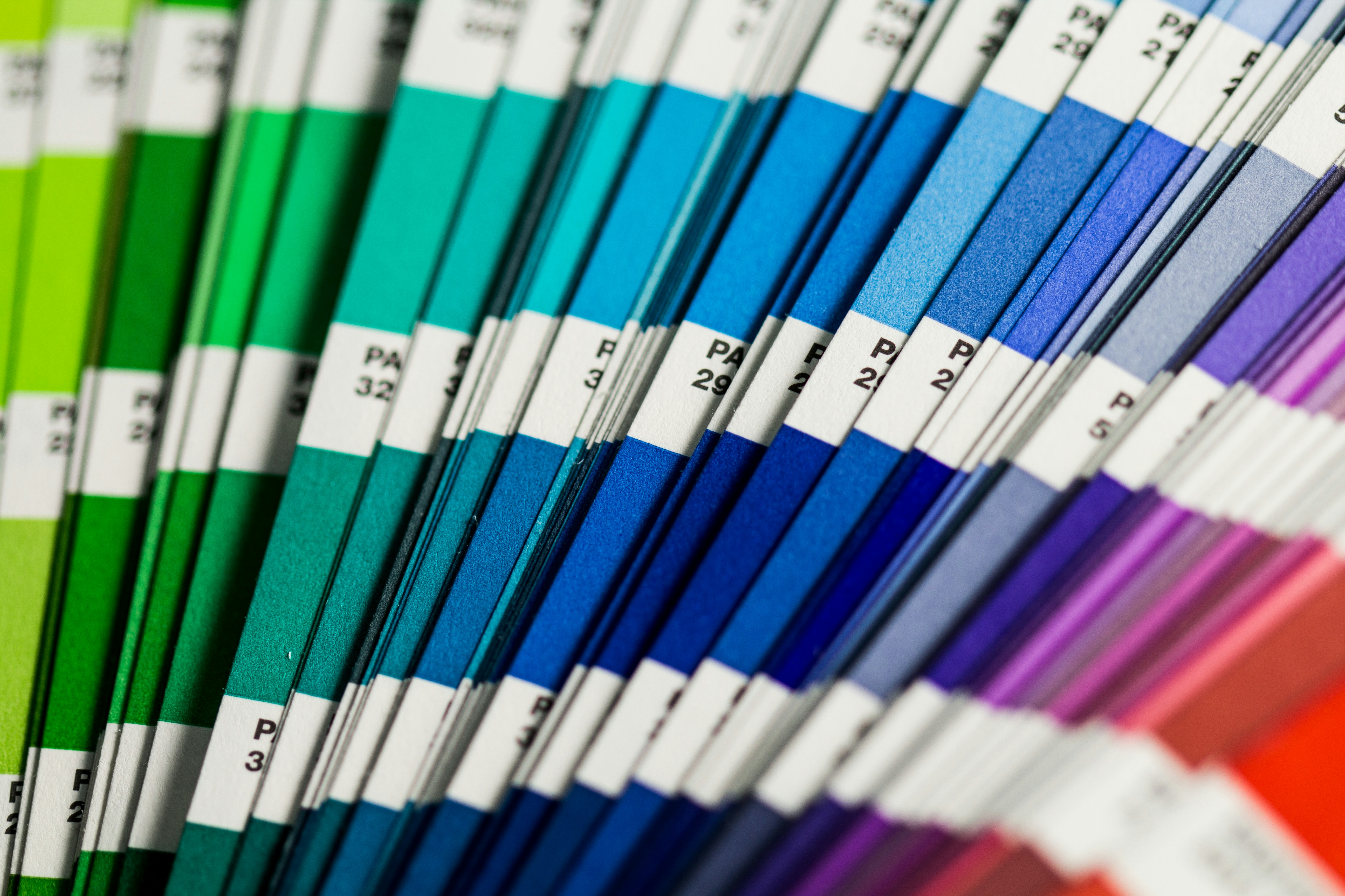 Close-up of a Pantone color swatch book displaying various shades