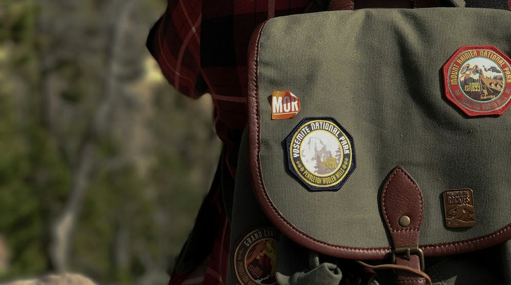 A close-up of a backpack with national park patches A close-up of a backpack with national park patches