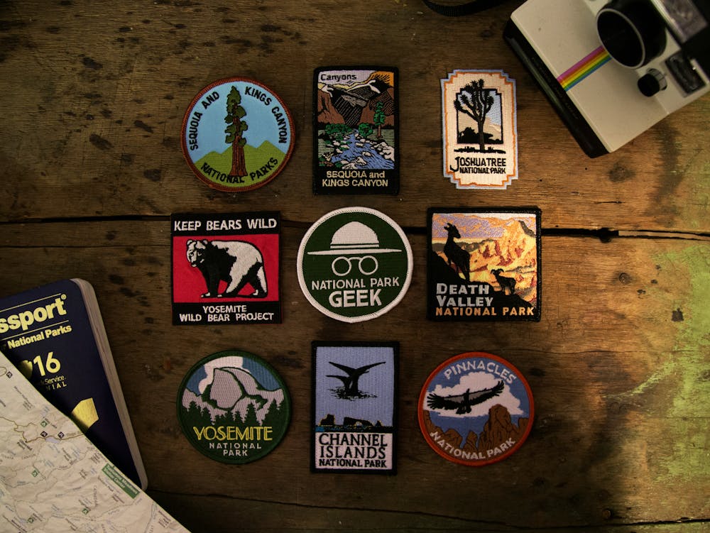 A collection of colorful embroidered national park patches A collection of colorful embroidered national park patches