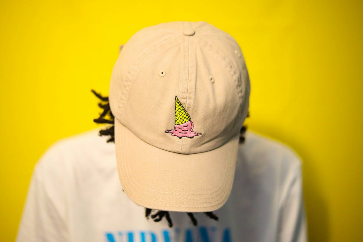 someone wearing a baseball cap with a patch on the front someone wearing a baseball cap with a patch on the front