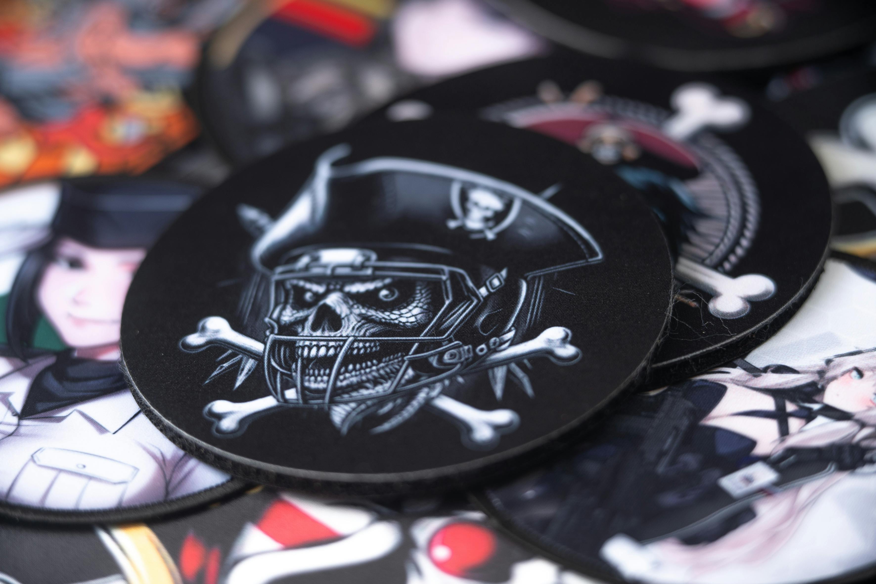  A printed patch featuring a detailed pirate design, with various other colorful patches visible in the background.