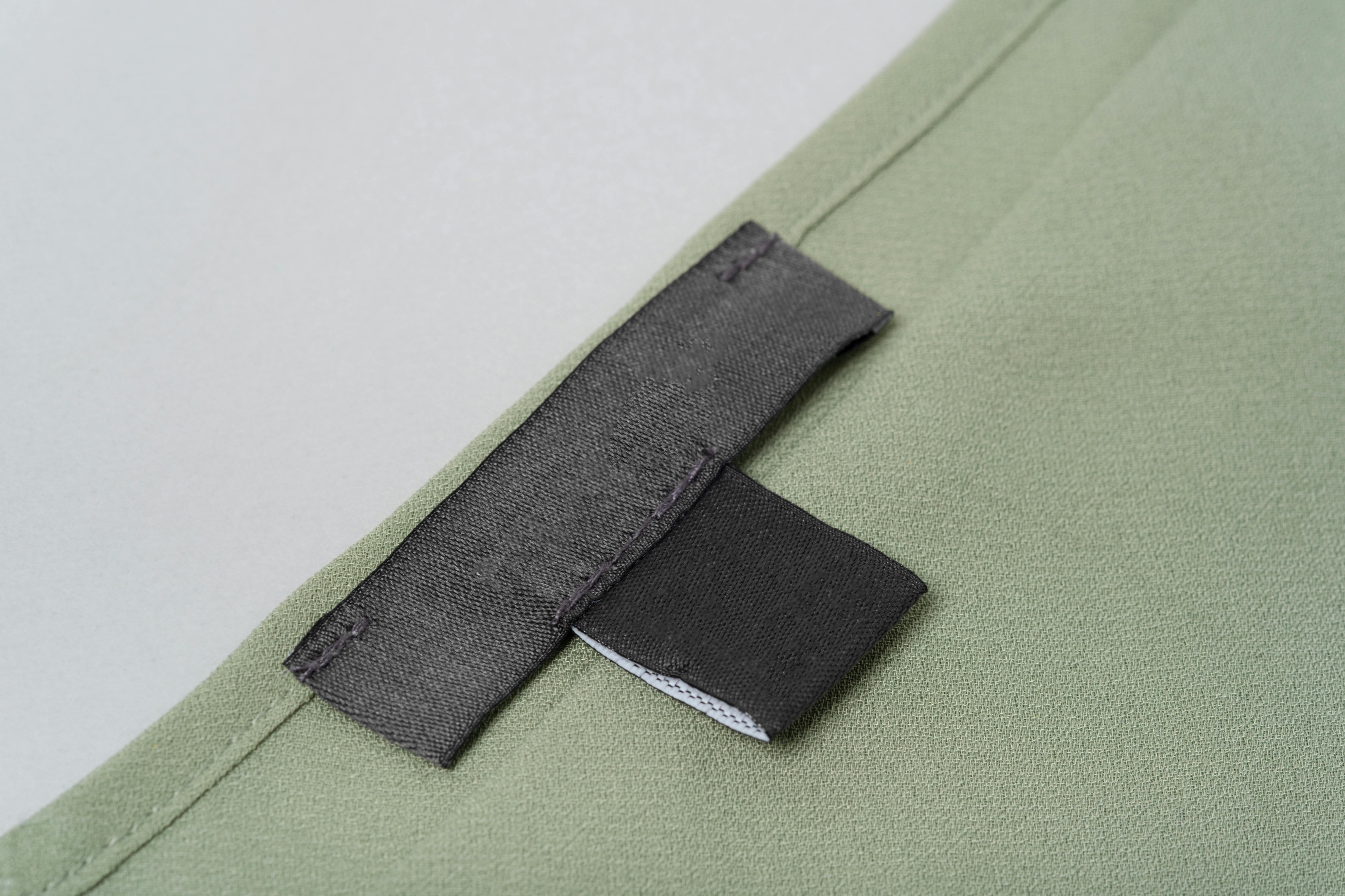  clothing label sewn onto green top