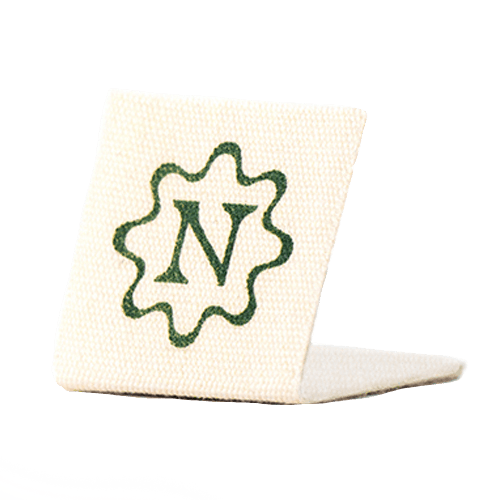  Etiqueta de algodón impresa con pliegue central y estampado verde.