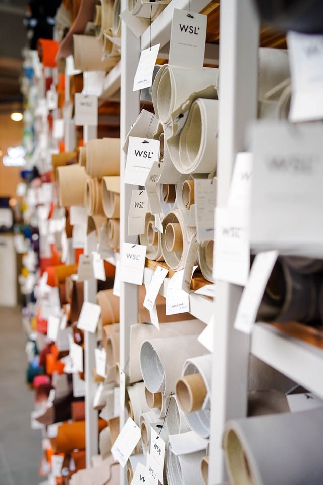  rolls of vinyl and leather on racks in a store