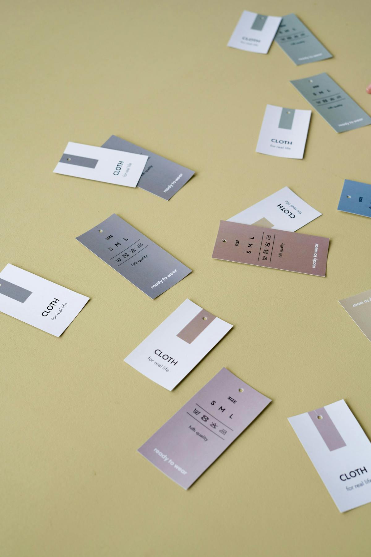 A collection of hang tags laying on a monochromatic background A collection of hang tags laying on a monochromatic background