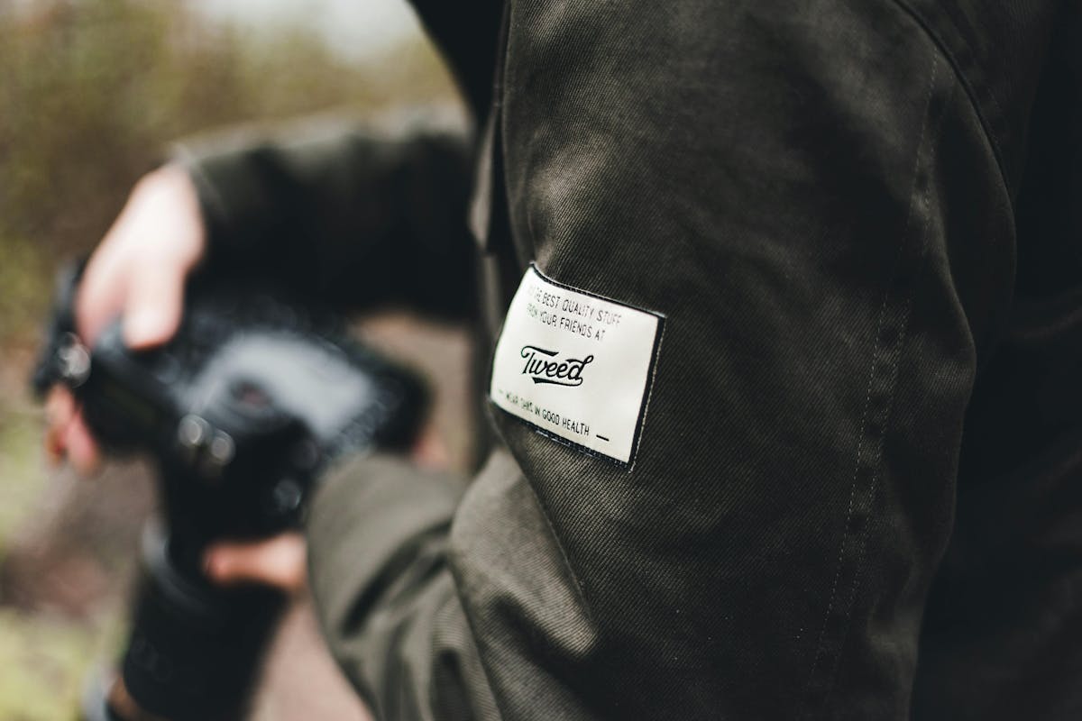 Close-up of a branded clothing label on the sleeve of a dark green jacket Close-up of a branded clothing label on the sleeve of a dark green jacket