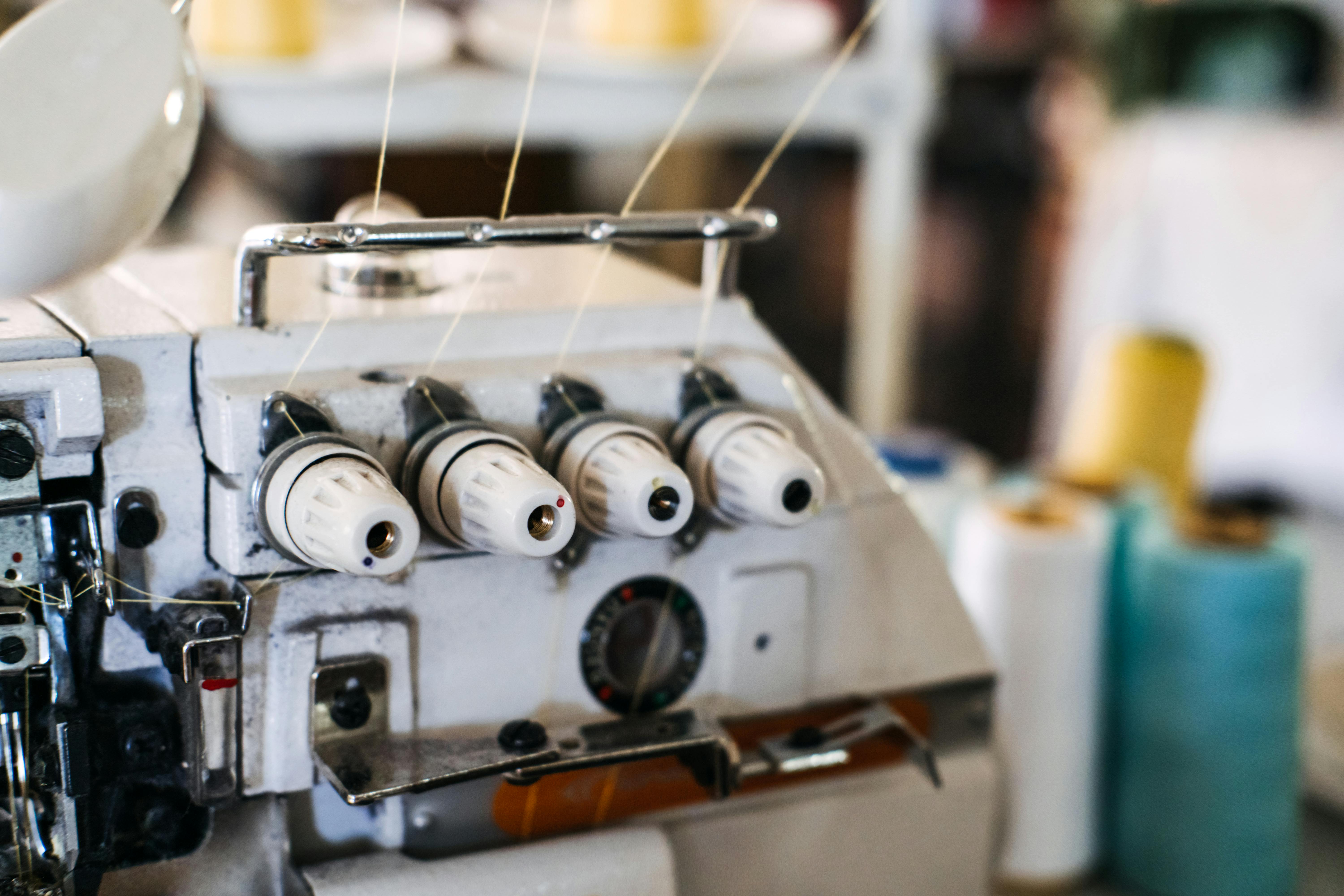  close up photo of a serger machine with threads