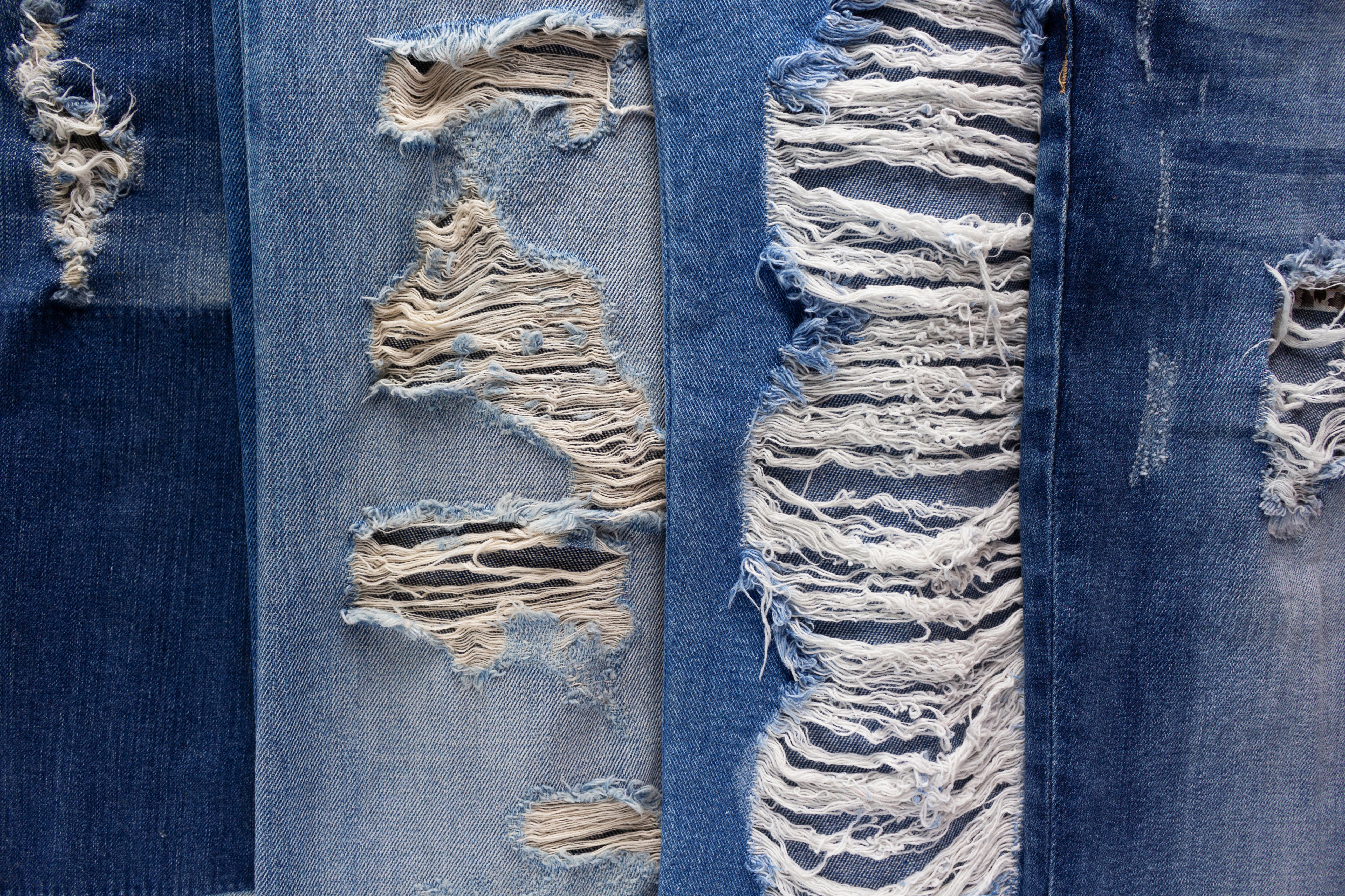  four different types of ripped denim jeans 