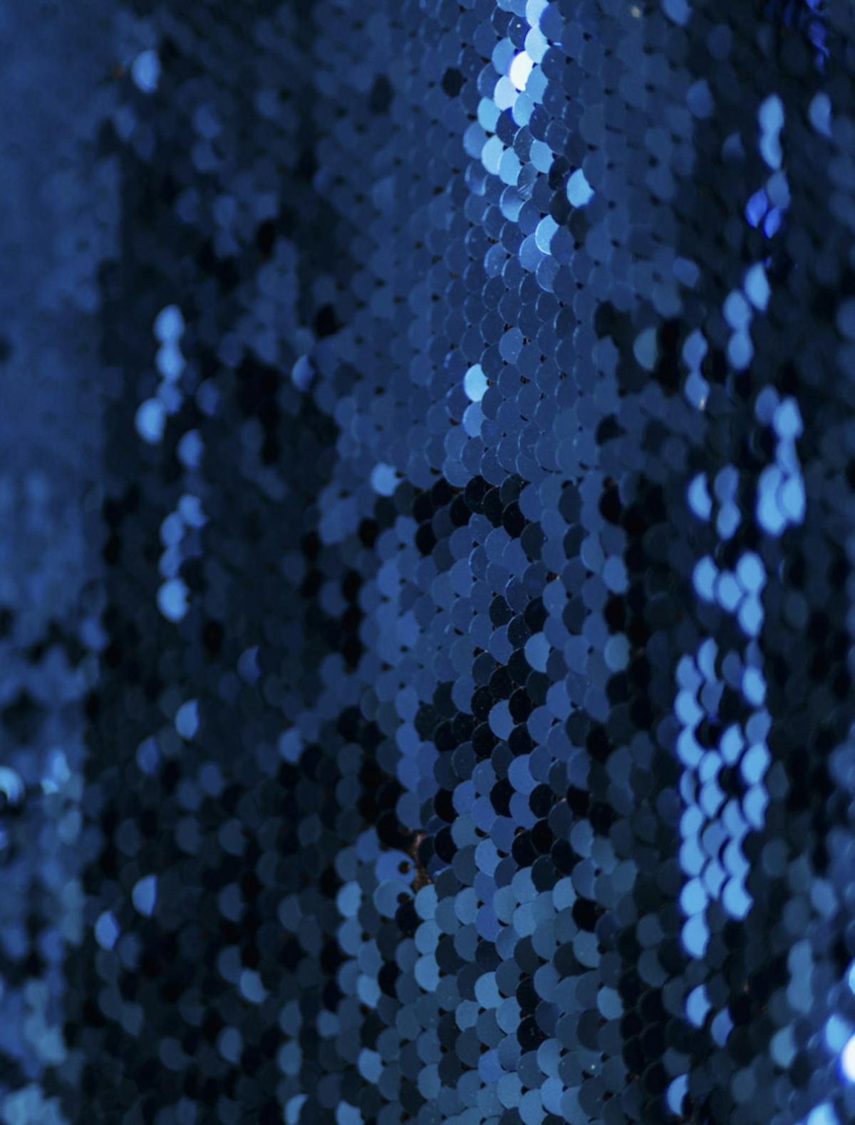  Close up photograph of navy blue sequin fabric