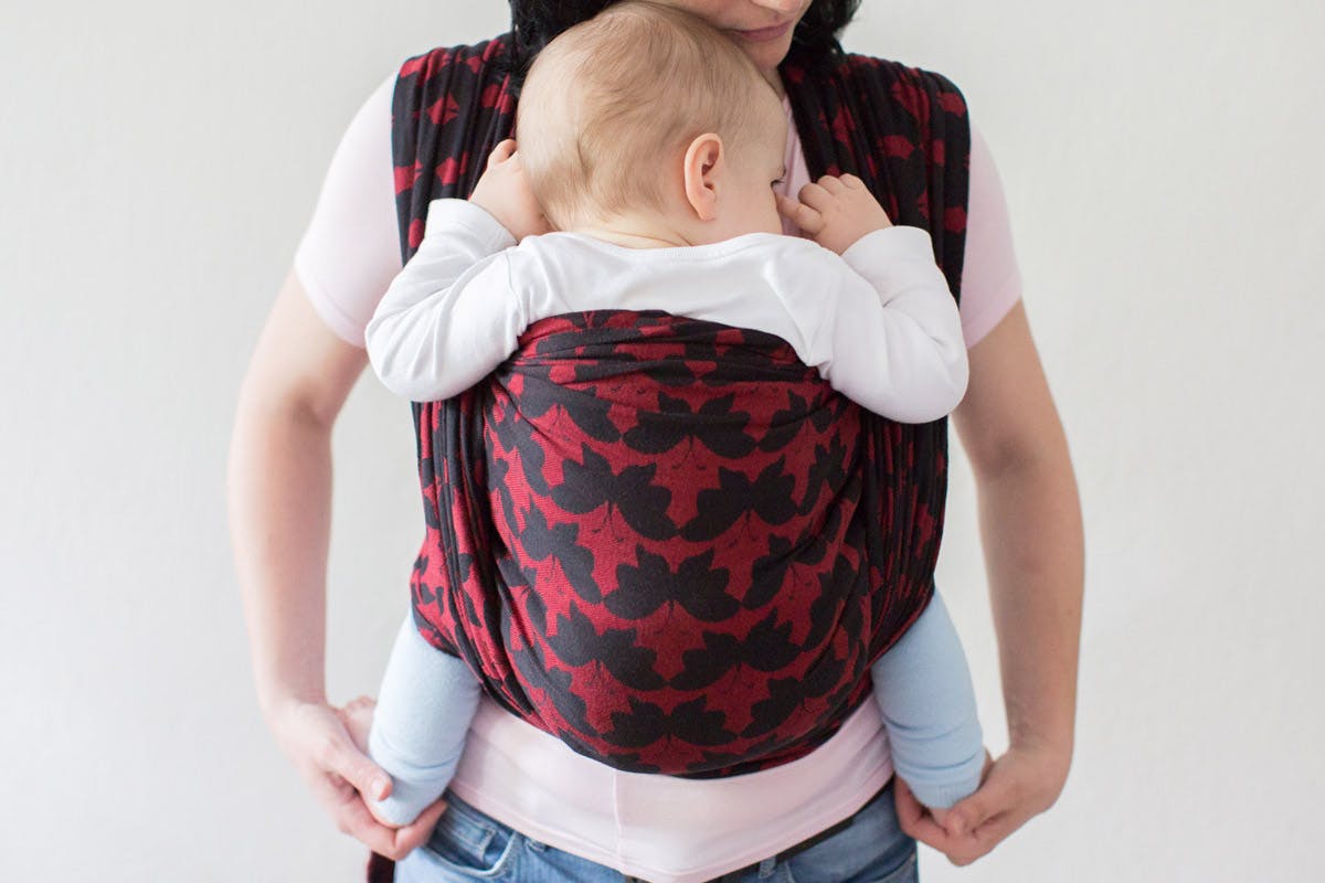  baby in patterned cloth baby carrier