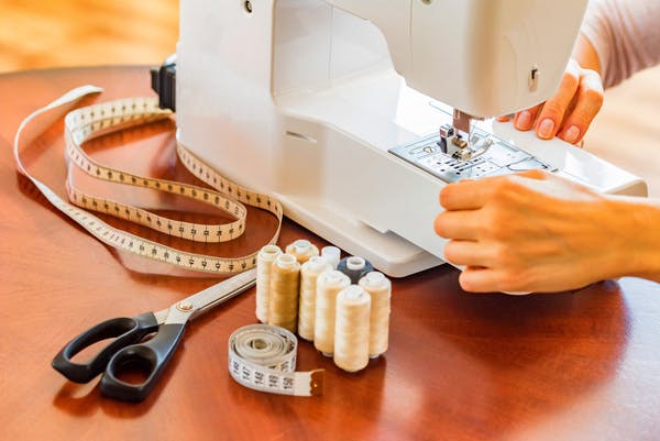  person preparing sewing machine