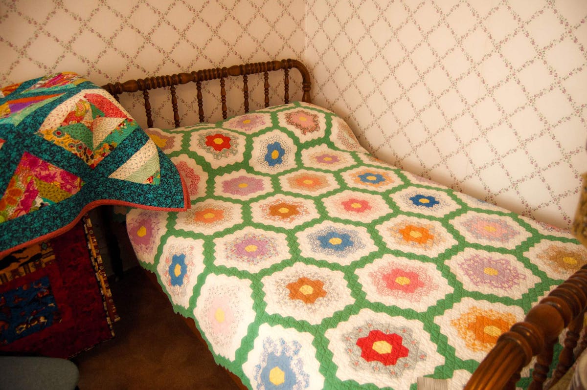  antique quilt on wooden bed