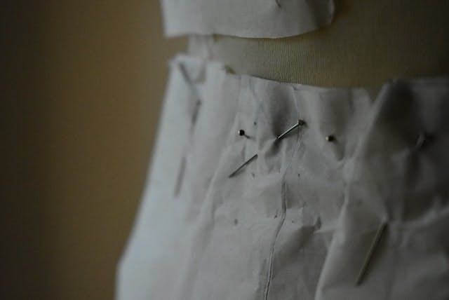  Close up of a sewing project with pins on a mannequin 