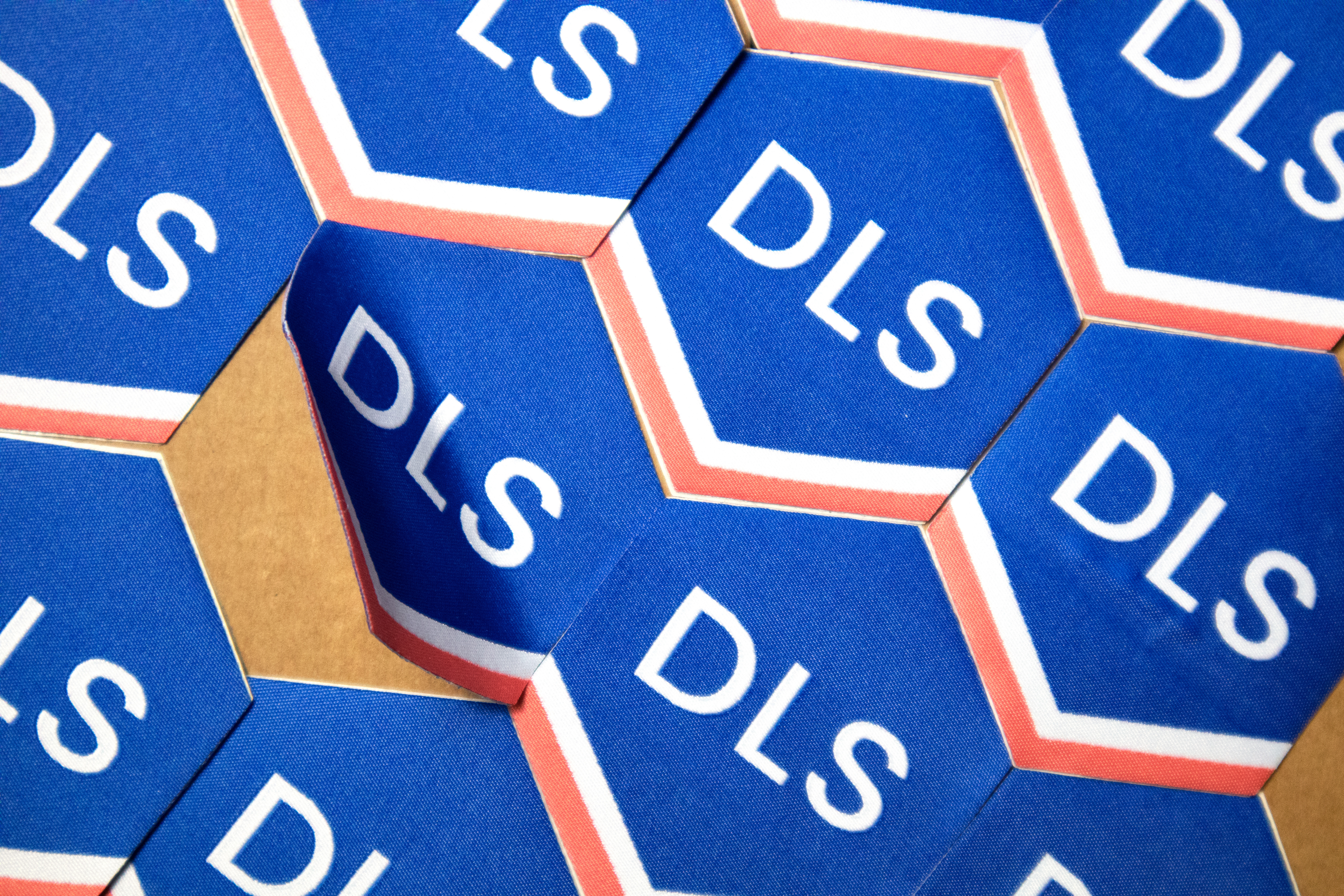 Woven Stickers being stuck to a wooden surface