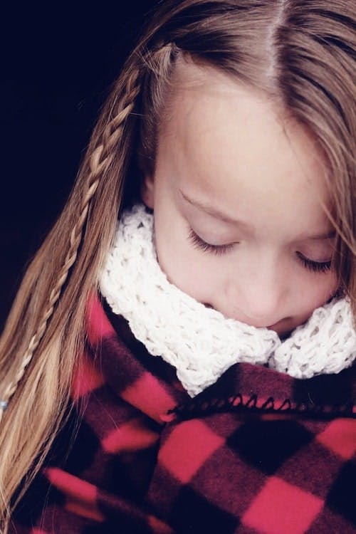  girl wrapped up in a flannel blanket