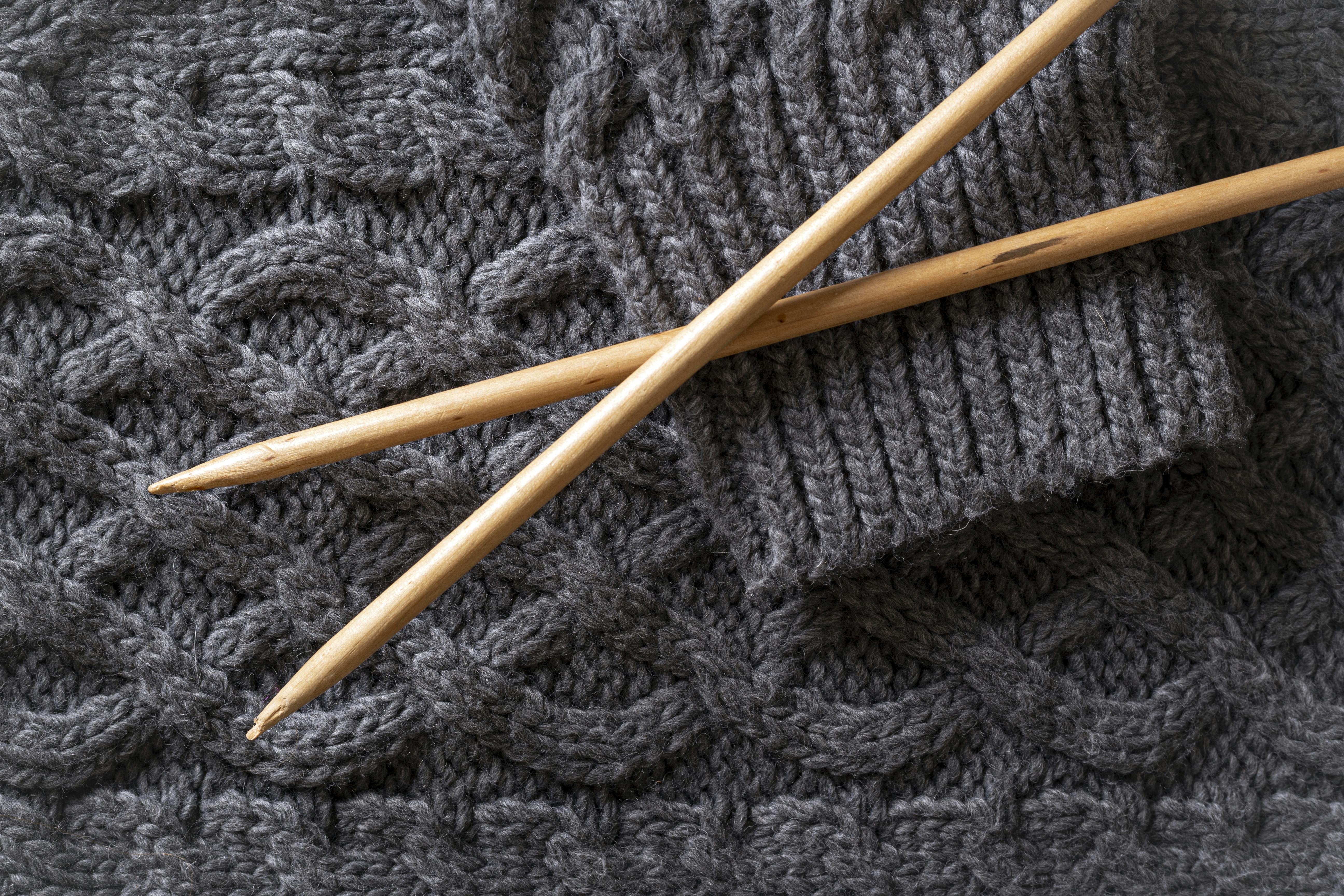  close up of cable knit technique on grey sweater