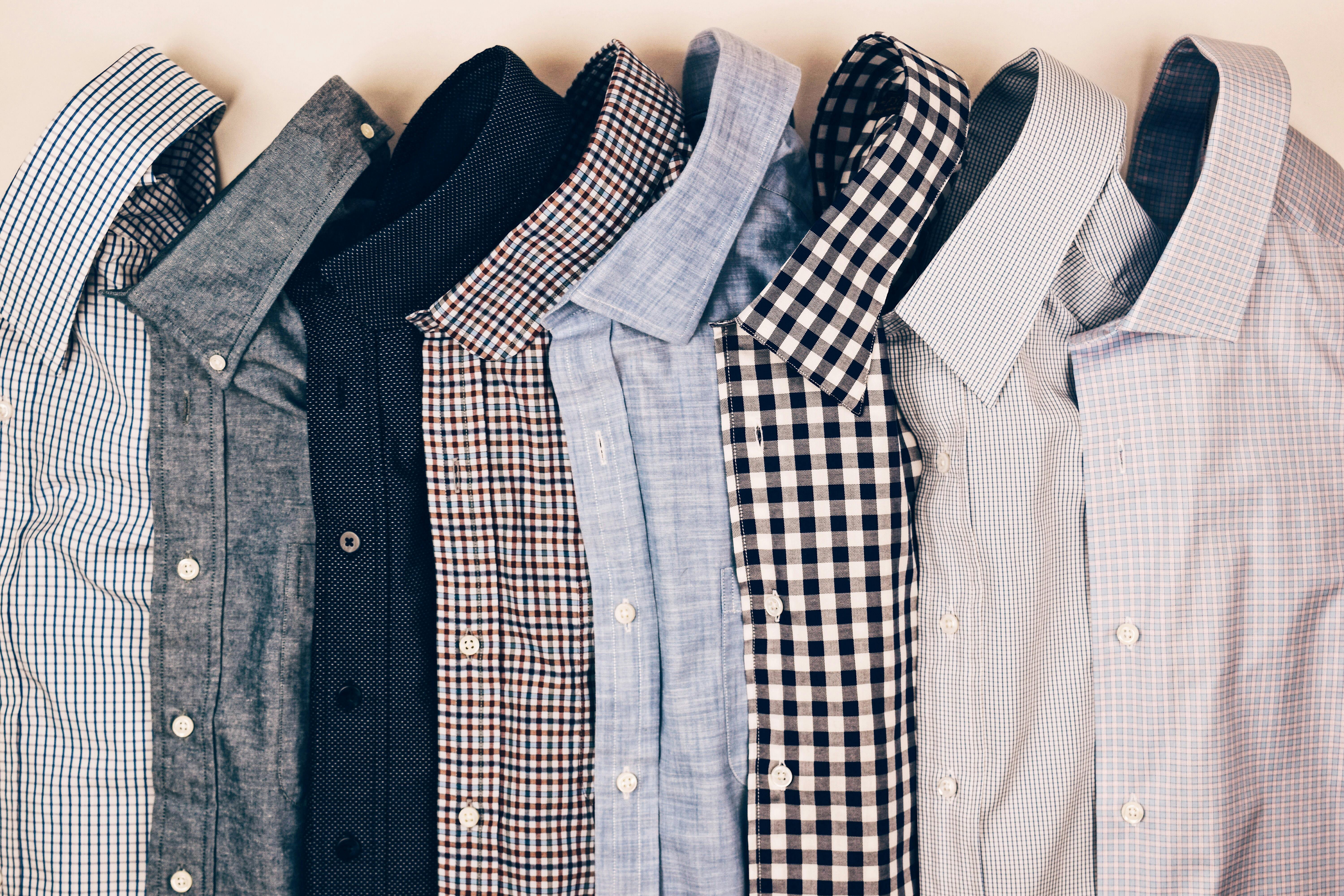 photograph of mens shirts folded and lined up in a row