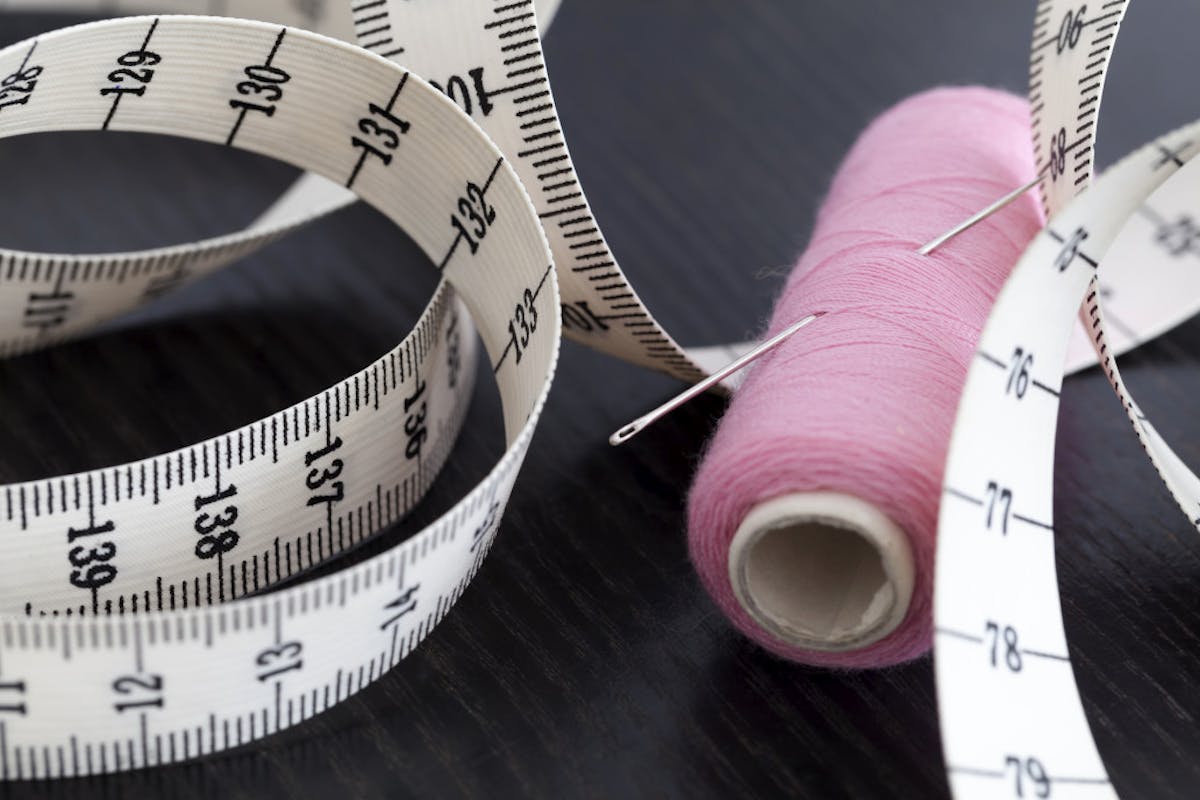 needle, thread, and measuring tape needle, thread, and measuring tape