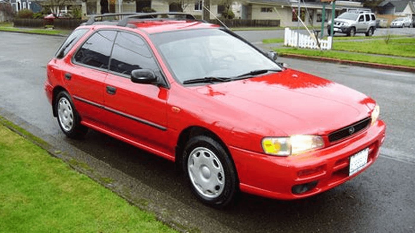 semi modern red corolla on street