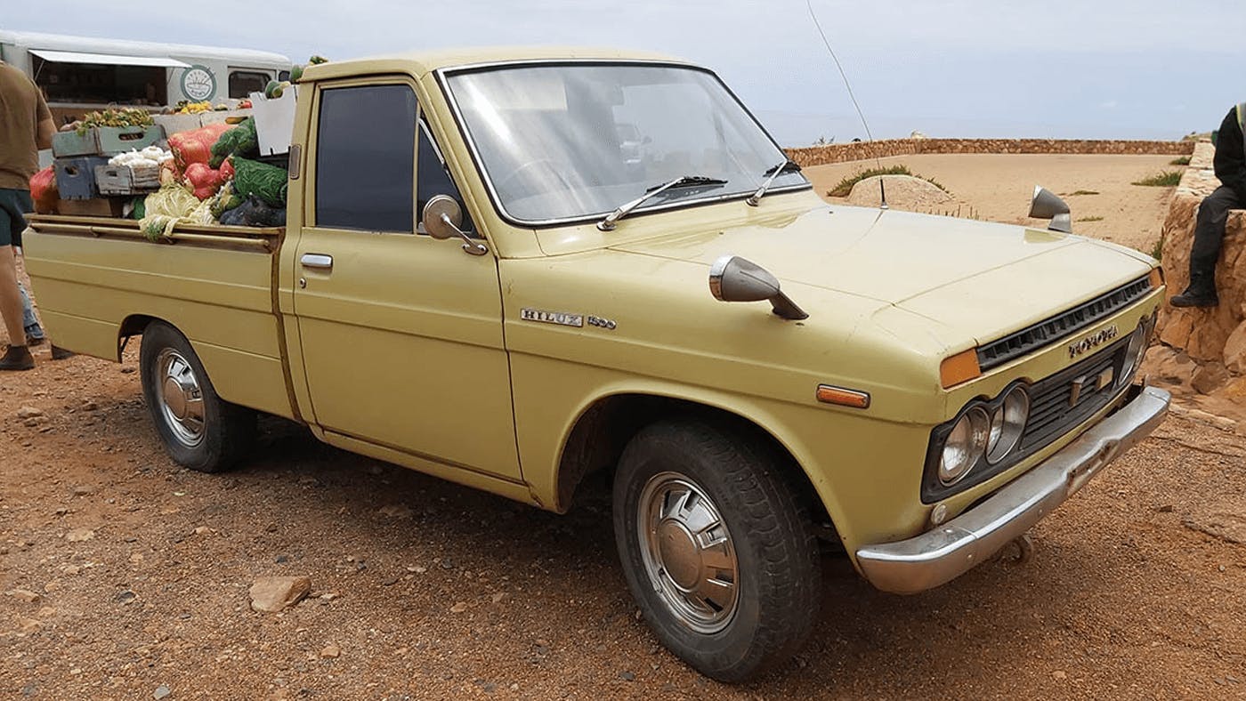 old toyota hilux with groceries in tray