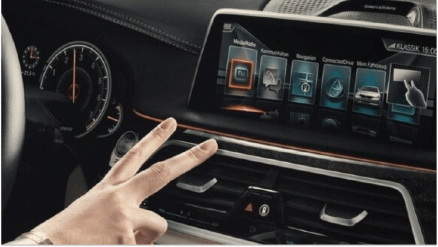 Hand using gesture control signals to operate in-car technology