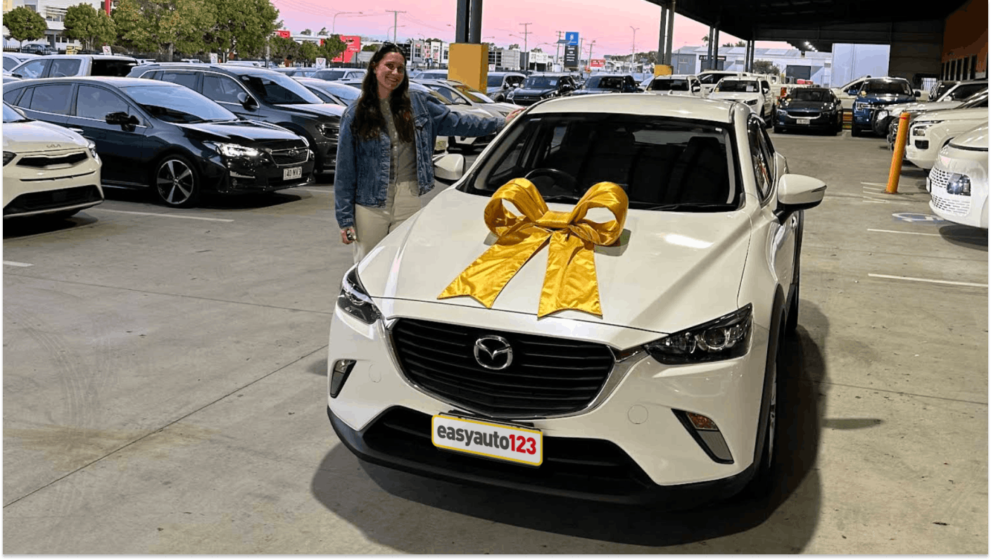Happy Hendra customer with with Mazda CX-3 and a gold bow on the bonnet