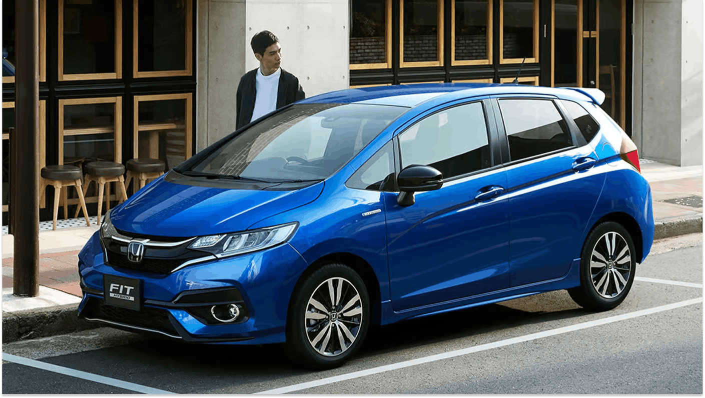 Blue Honda Jazz parked on city street