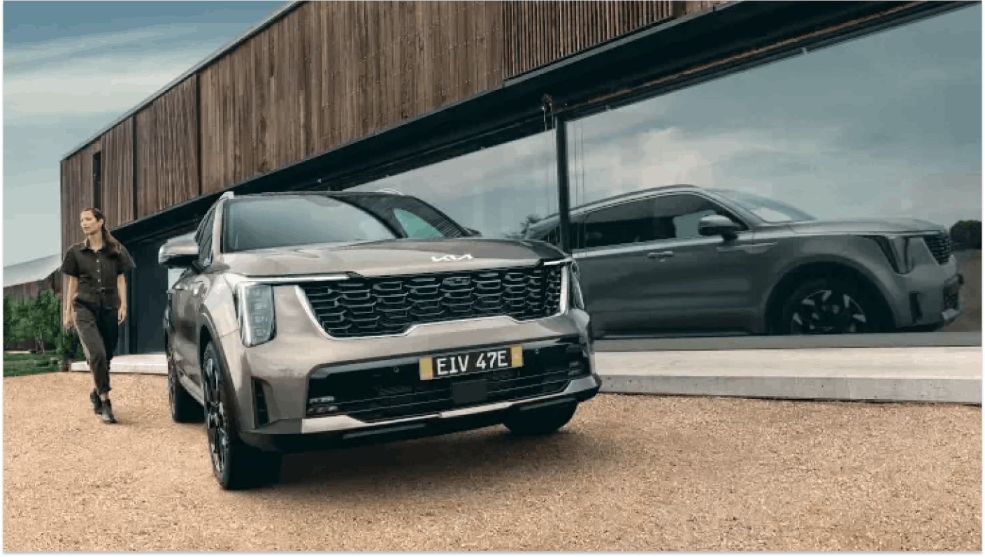 Kia Carnival in front of designer house