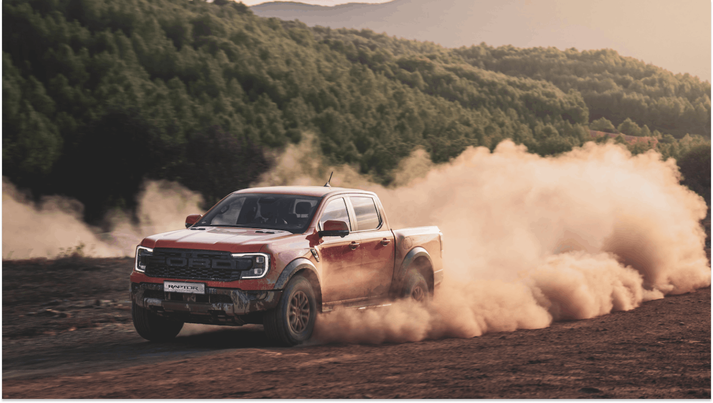 Ford Ranger speeding across dusty field