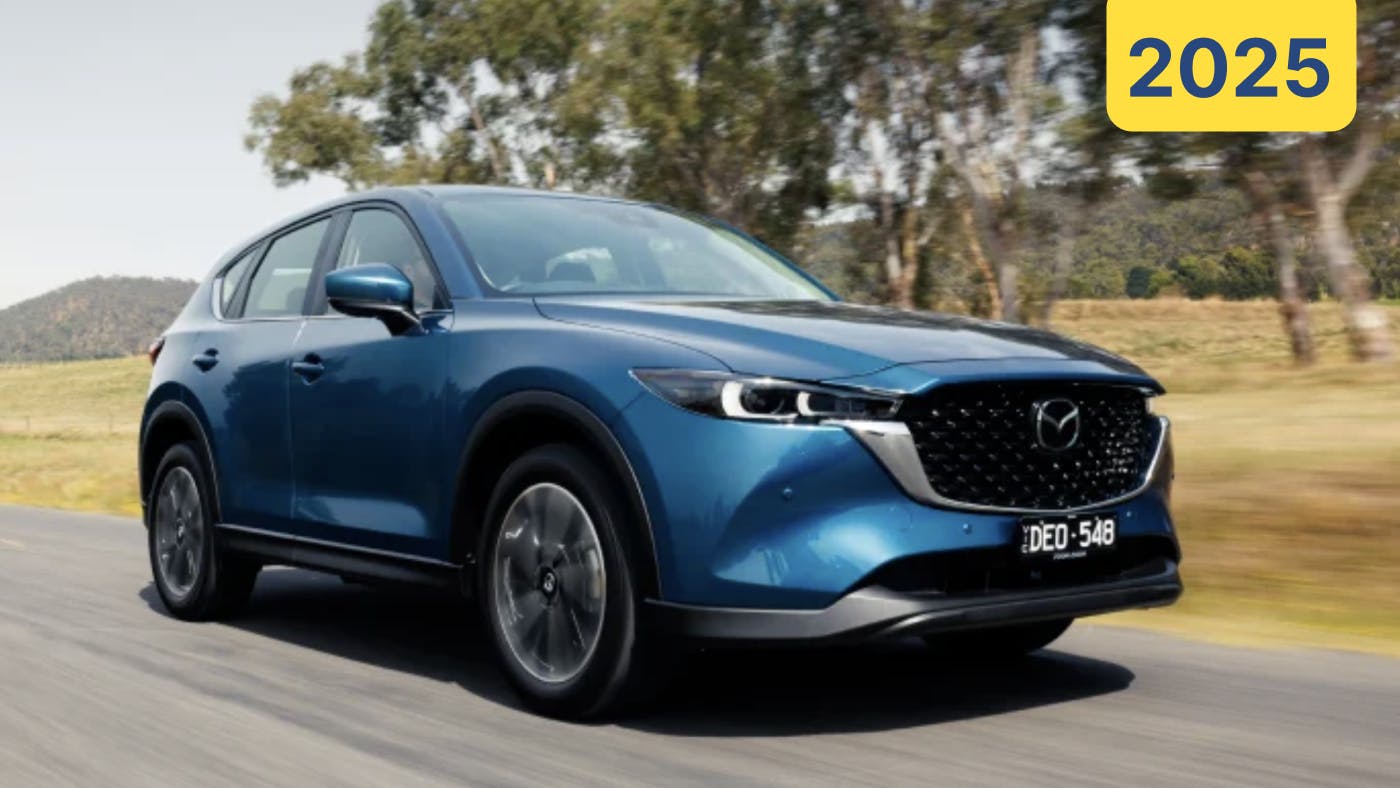 2025 Mazda CX-5 in blue driving left to right
